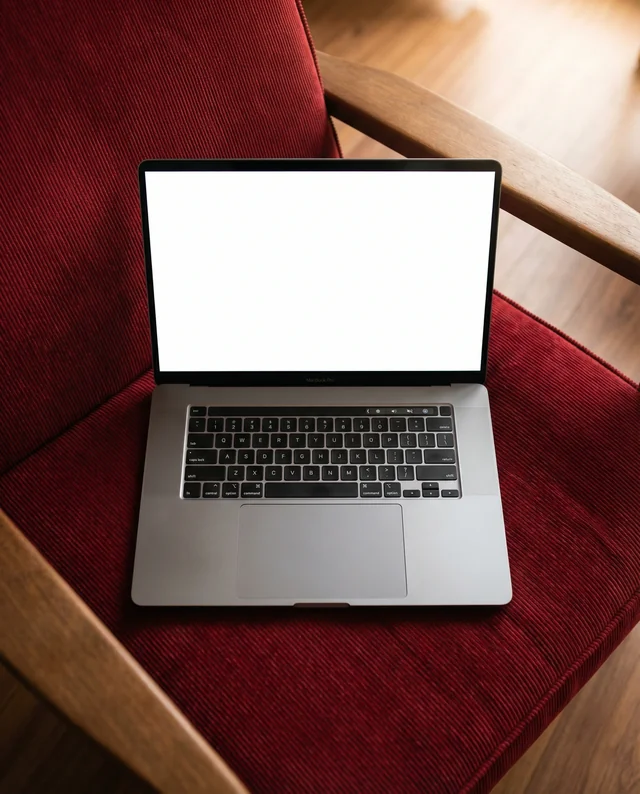 Elegant MacBook Mockup on Cozy Armchair