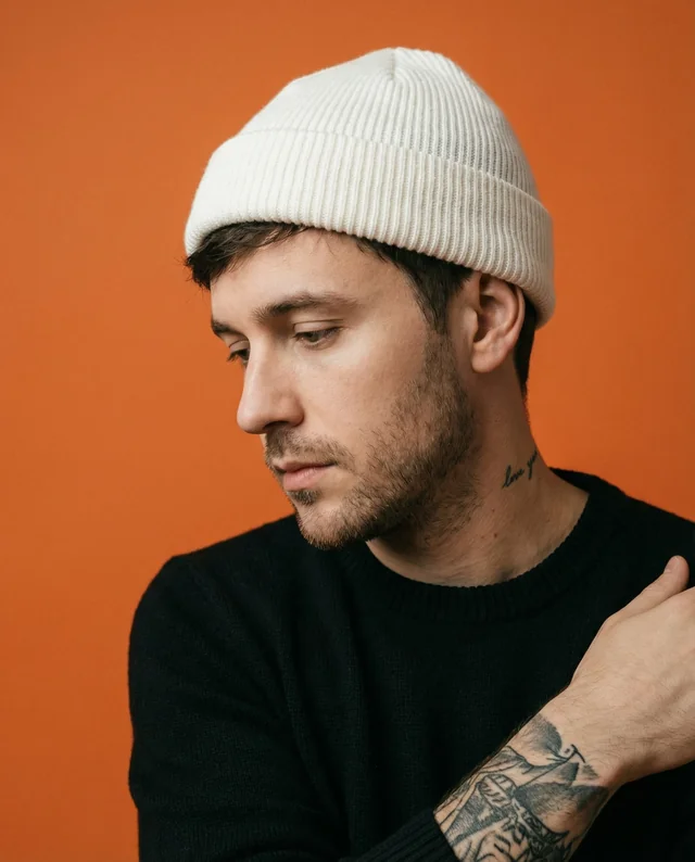 Thoughtful Young Man in White Beanie Mockup Portrait