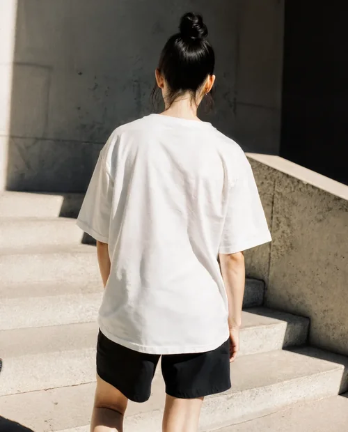 Stylish T-Shirt Mockup of a Young Woman in Urban Setting