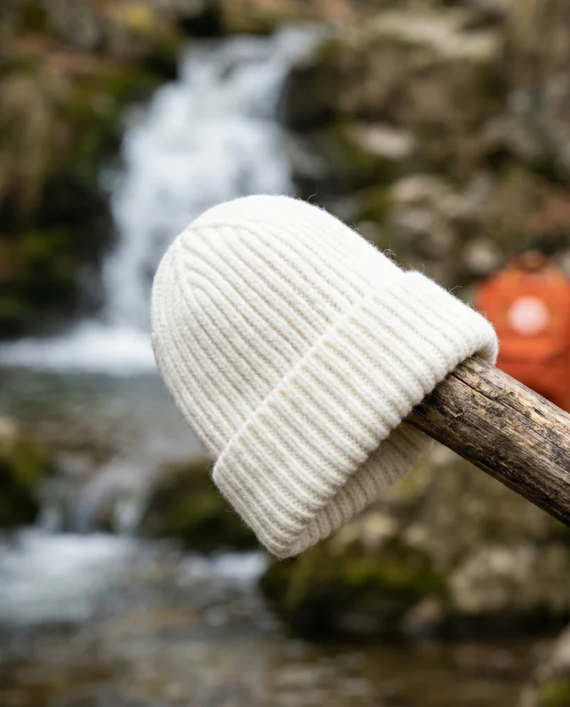 Cozy Cream Beanie Mockup by a Serene Waterfall