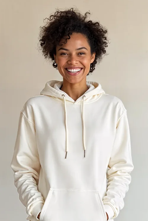 Joyful Woman in Cream Hoodie Against Soft Neutral Background