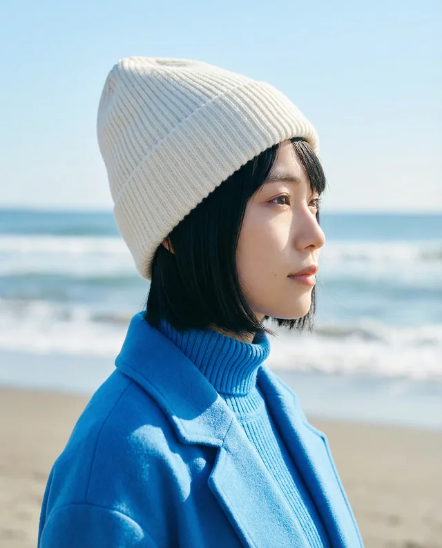 Young Woman in Beanie Mockup on Serene Beach Scene