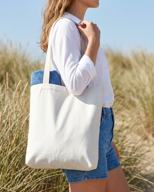 Summer Tote Bag Mockup with Young Woman at the Beach