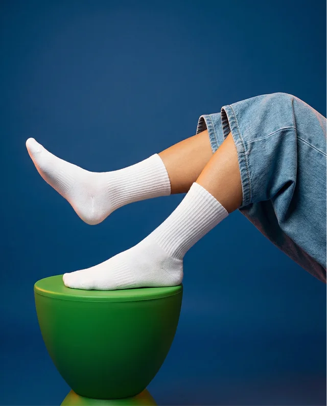 Playful Mockup of Feet in White Socks on Green Stool