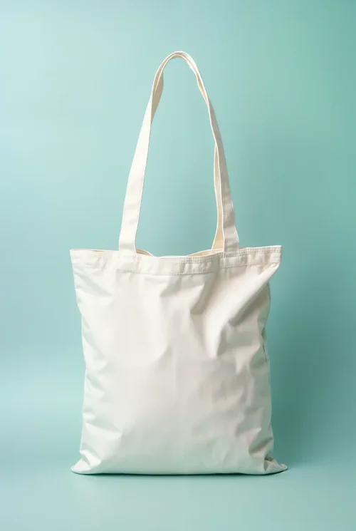 Stylish Mockup of a White Cotton Tote Bag on Light Blue