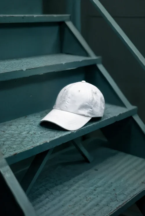 Stylish Mockup of a Hat on Weathered Teal Stairs