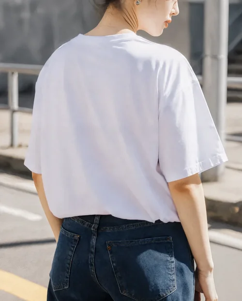 Casual T-Shirt Mockup Featuring Young Woman Outdoors