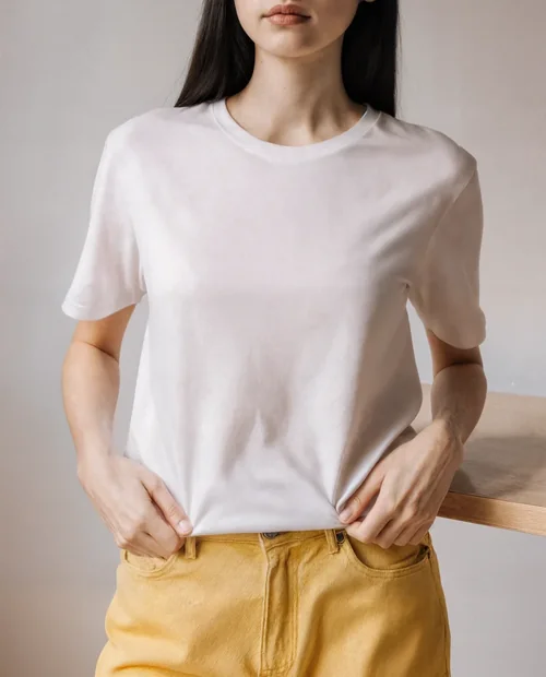 Stylish T-Shirt Mockup of Young Woman in Minimalist Setting