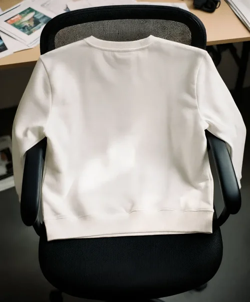 Minimalist Mockup of Cream Sweatshirt in Workspace