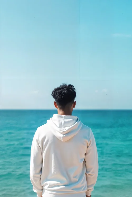 Serene Mockup of a Hoodie Against Vibrant Ocean Colors