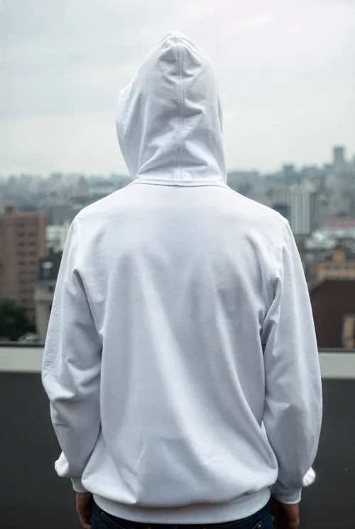 Urban Mockup of White Hoodie Against Moody City Background
