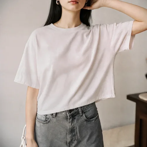 Stylish T-Shirt Mockup of a Confident Young Woman