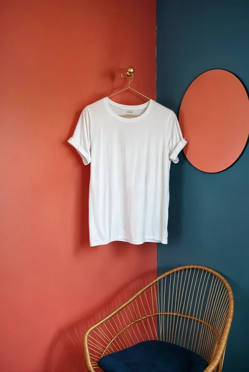 Minimalist T-Shirt Mockup Against Coral-Red Wall