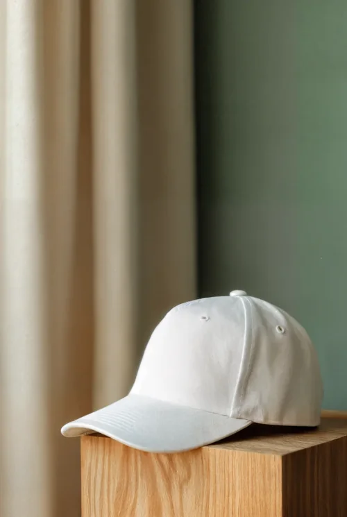 Stylish Mockup of a White Hat on a Wooden Pedestal