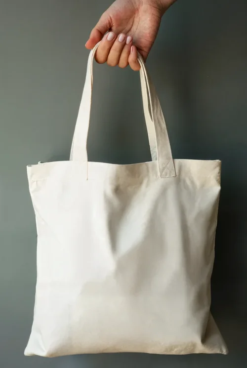 Elegant Beige Tote Bag Mockup Against Gray Background