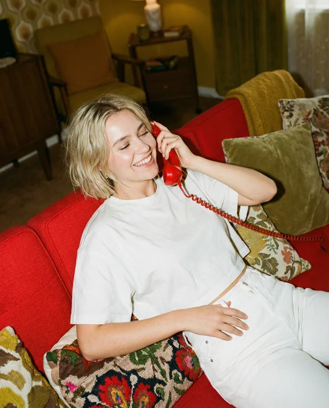 Cheerful Woman in Crop Top on Red Couch Mockup