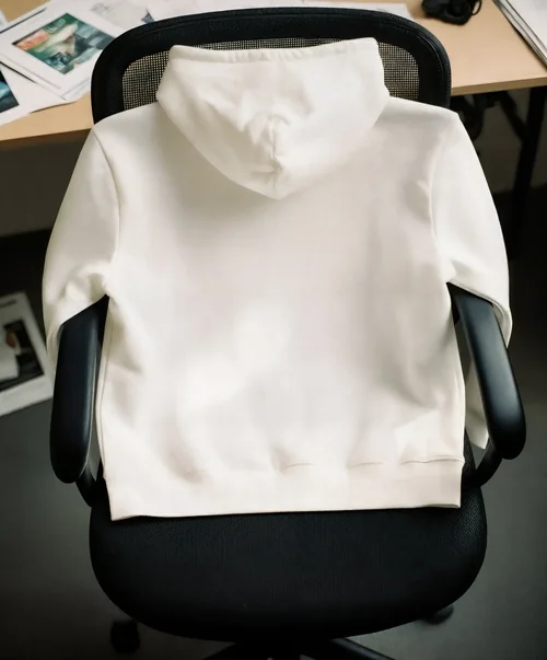Minimalist Mockup of a Hoodie in a Modern Workspace