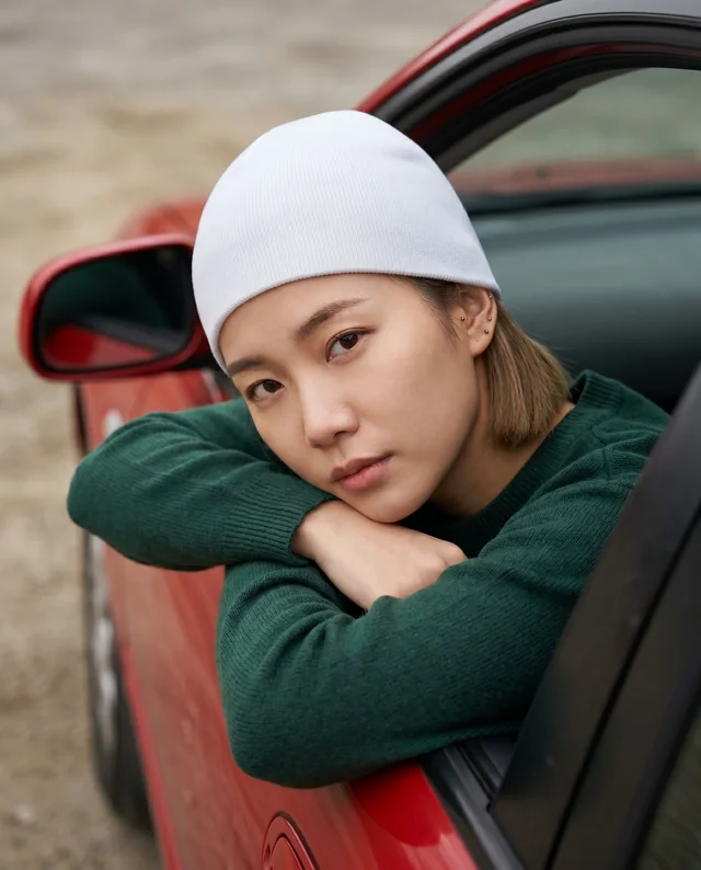 Young Woman in Beanie Mockup by Red Car Window