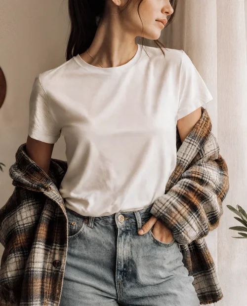 Stylish T-Shirt Mockup of a Young Woman in Cozy Setting