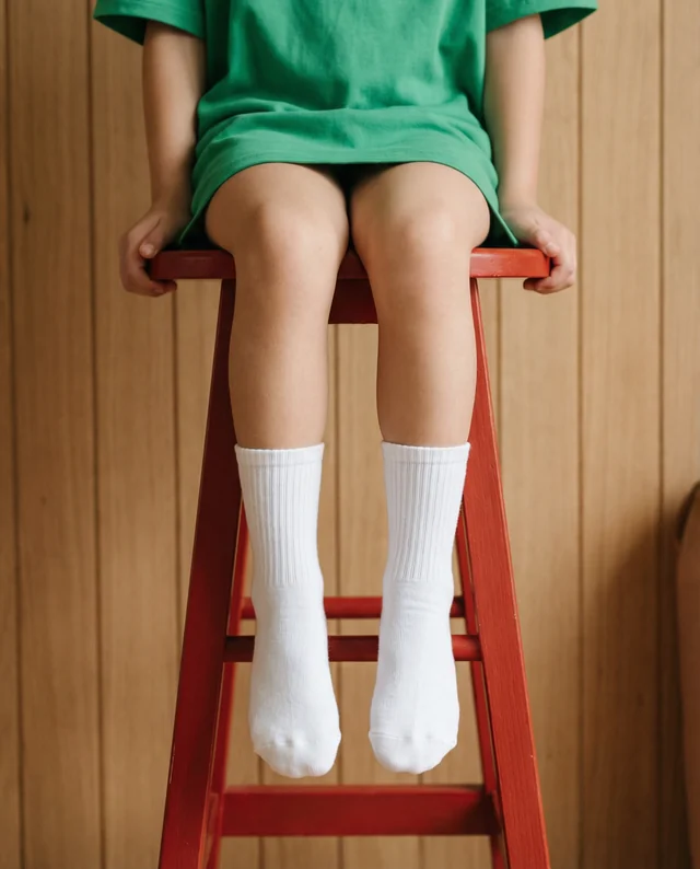 Charming Mockup of a Child in Socks on a Red Stool