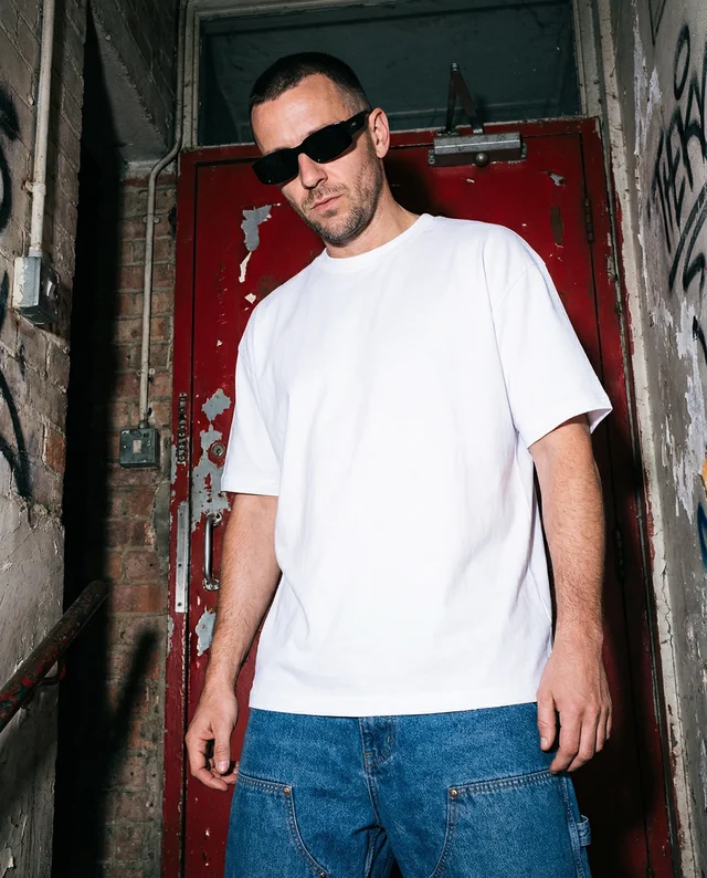 Urban T-Shirt Mockup Featuring Confident Male Model