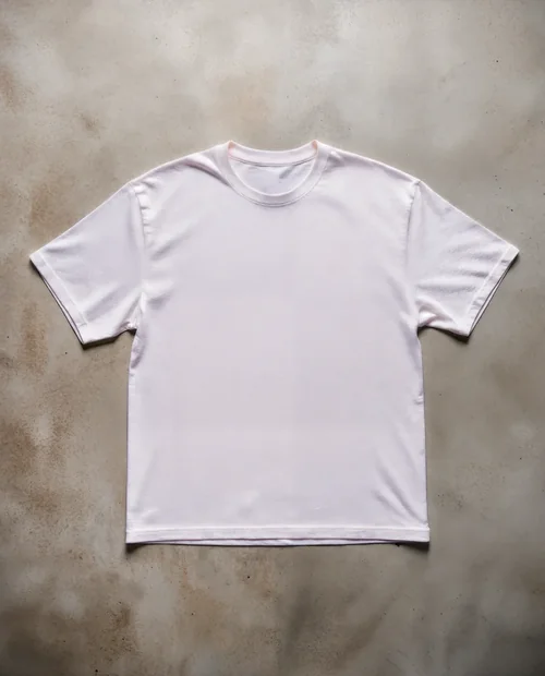 Mockup of a Soft Pastel Pink T-Shirt on Concrete Surface