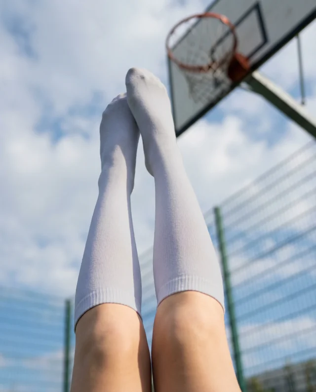 Playful Mockup of Legs in Light Gray Socks Outdoors