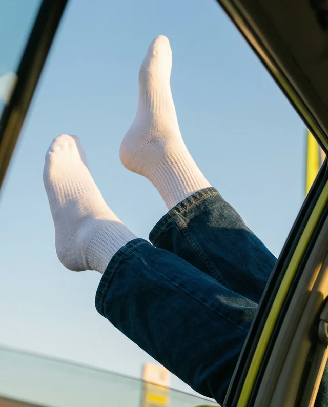 Playful Mockup of Feet in Socks by Car Window
