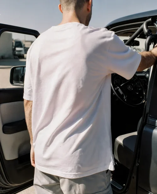 Casual T-Shirt Mockup with Person by a Car