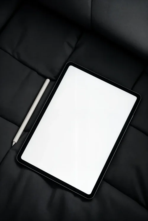 Sleek iPad Mockup on Dark Gray Couch - Minimalist Design