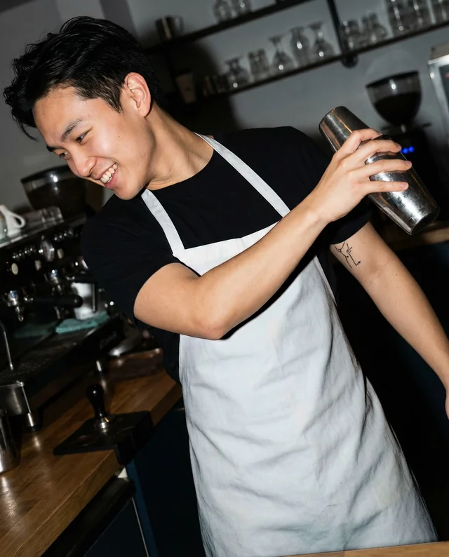 Modern Bartender Mockup with White Apron in Café Setting