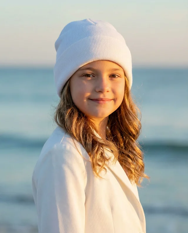 Young Girl in Cozy Beanie at Sunset Beach Mockup