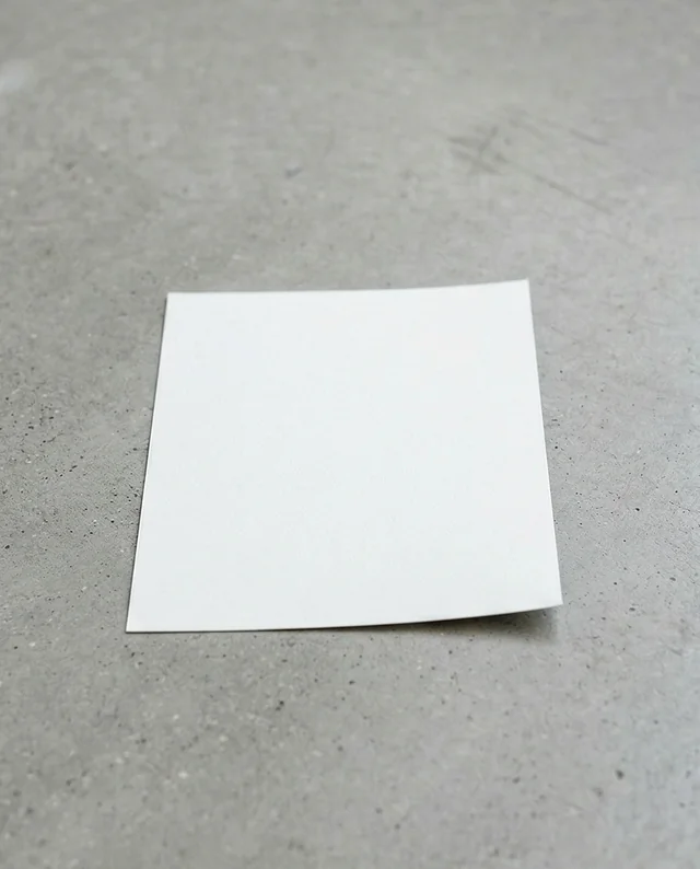 Elegant Mockup of a Curled White Flyer on Concrete Surface