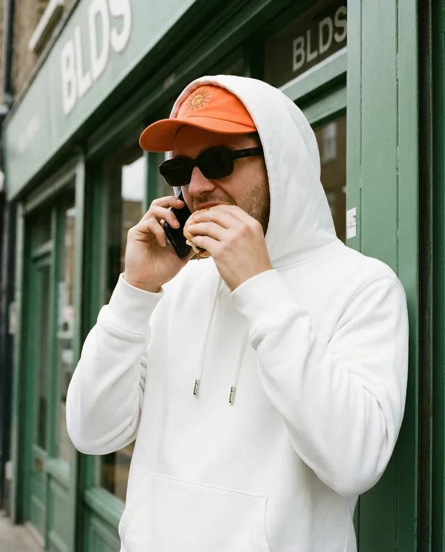 Urban Hoodie Mockup of a Young Man at Café
