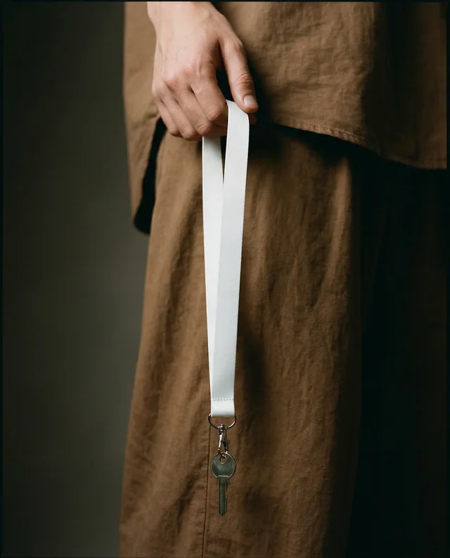 Elegant Mockup of a White Lanyard with Keys in Hand