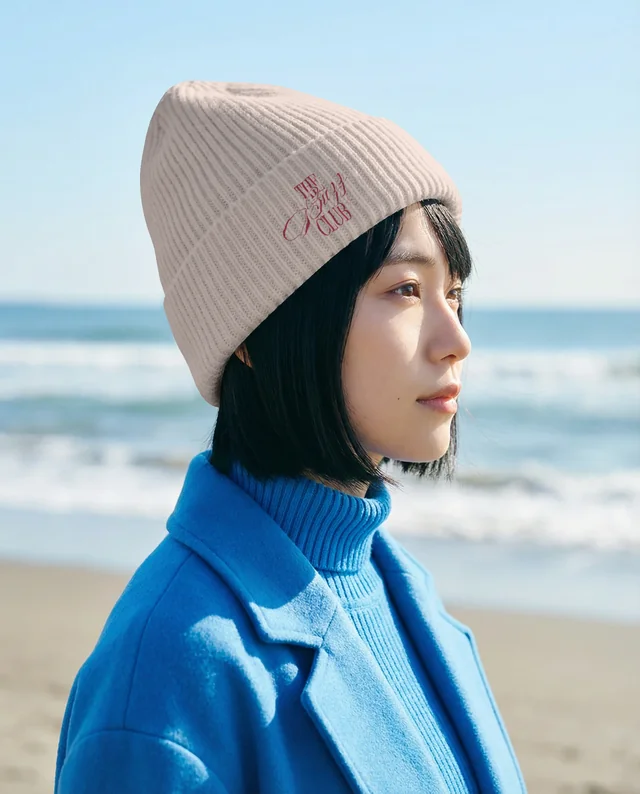 Young Woman in Beanie Mockup on Serene Beach Scene