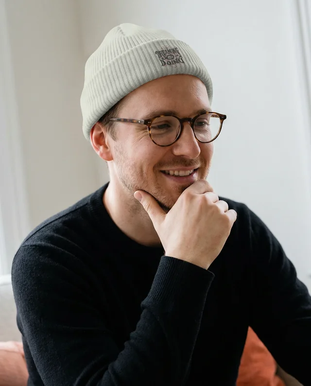 Thoughtful Young Man in Cozy Beanie Mockup Image