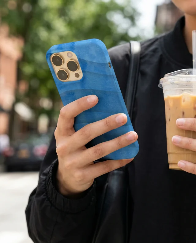 Urban Mockup of a Phone Cover with Iced Coffee in Hand