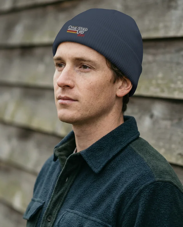 Young Man in Cream Beanie Mockup Against Rustic Background