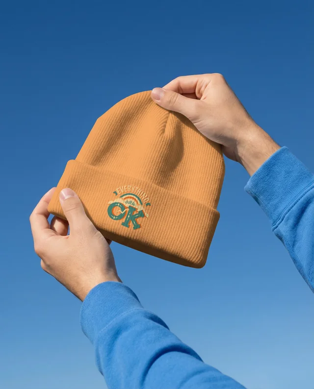 Elegant Mockup of a White Ribbed Beanie Against Blue Sky