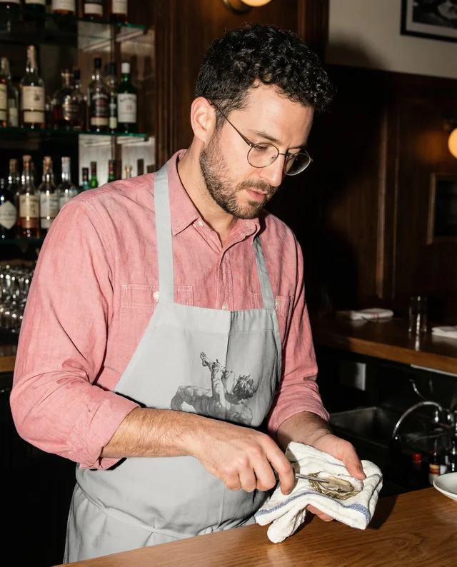 Bartender Mockup Skillfully Shucking Oysters in Bar
