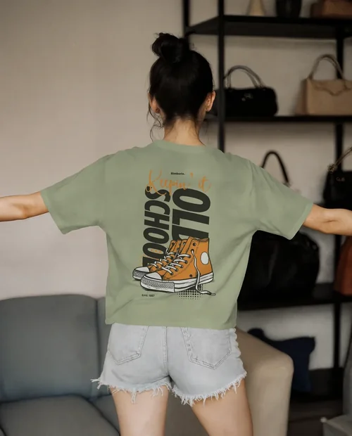 Stylish T-Shirt Mockup of a Young Woman in a Cozy Setting