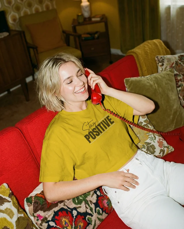 Cheerful Woman in Crop Top on Red Couch Mockup