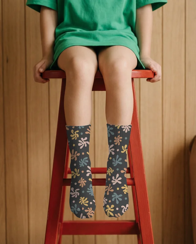 Charming Mockup of a Child in Socks on a Red Stool