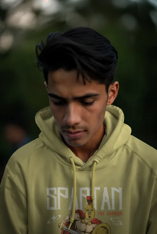 Mockup of Hoodie Against Soft Green Background Colors