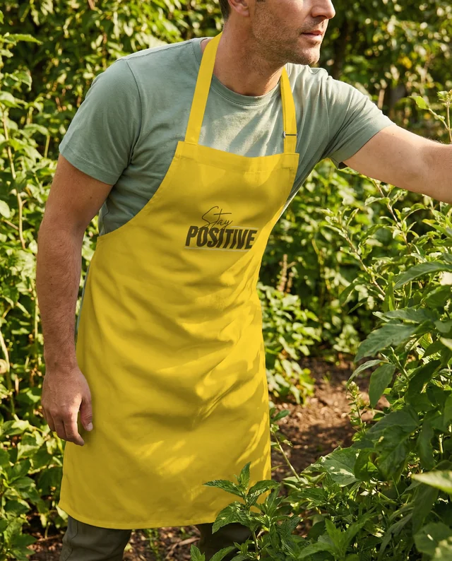 Man in Olive T-Shirt and White Apron in Lush Garden Mockup