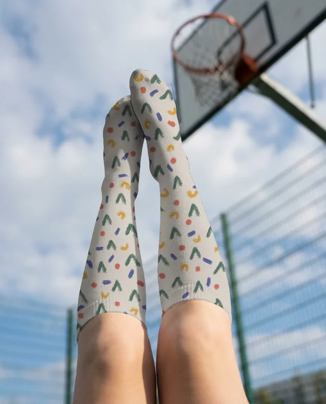 Playful Mockup of Legs in Light Gray Socks Outdoors