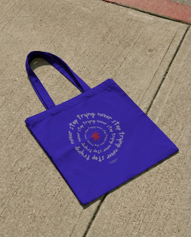 Minimalist Mockup of a White Tote Bag on Concrete