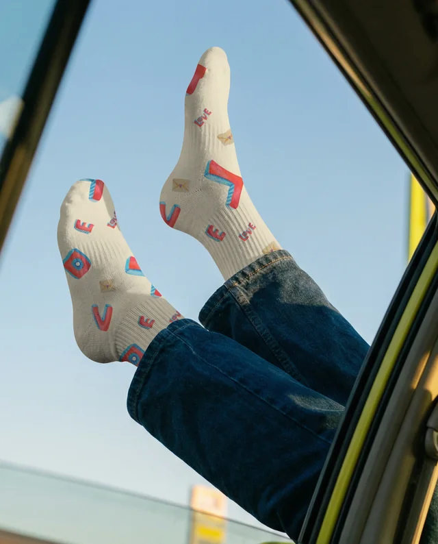 Playful Mockup of Feet in Socks by Car Window