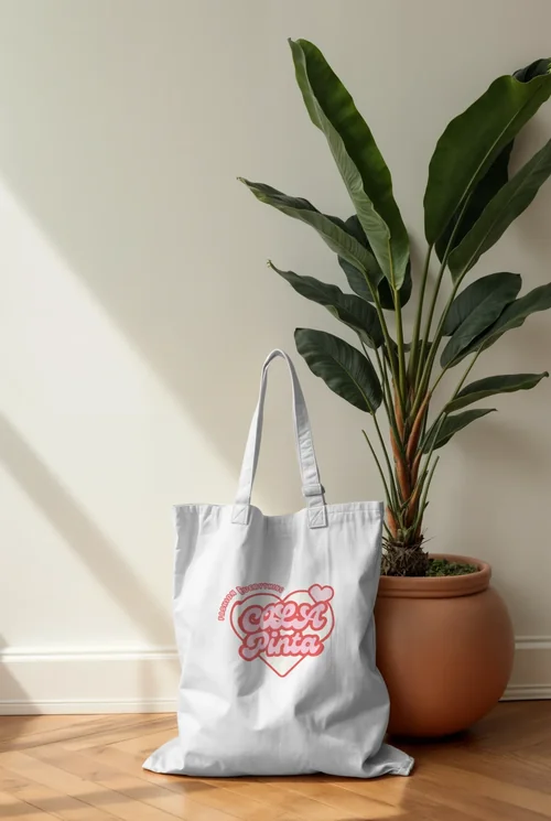 Creamy Mockup of a Minimalist Tote Bag on Wood Floor